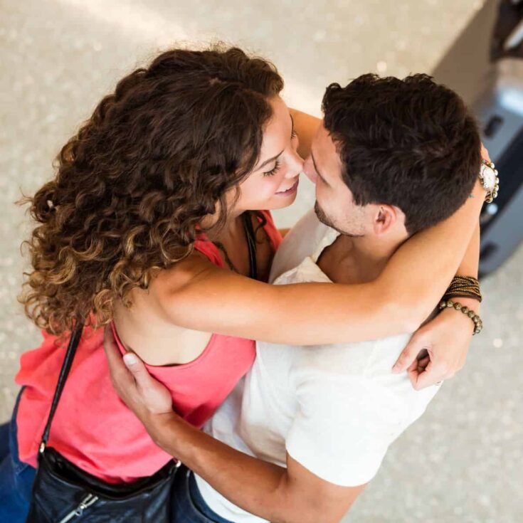 A couple hugging each other as they reunited: Long distance date ideas