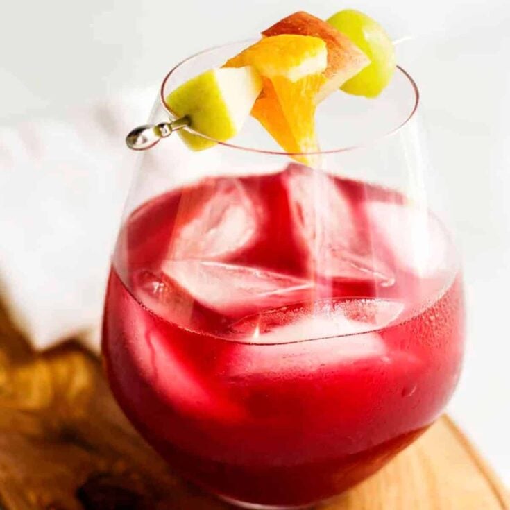Non-alcoholic sangria with a small fruit skewers on top, made after reading these pink drinks for Valentine's Day