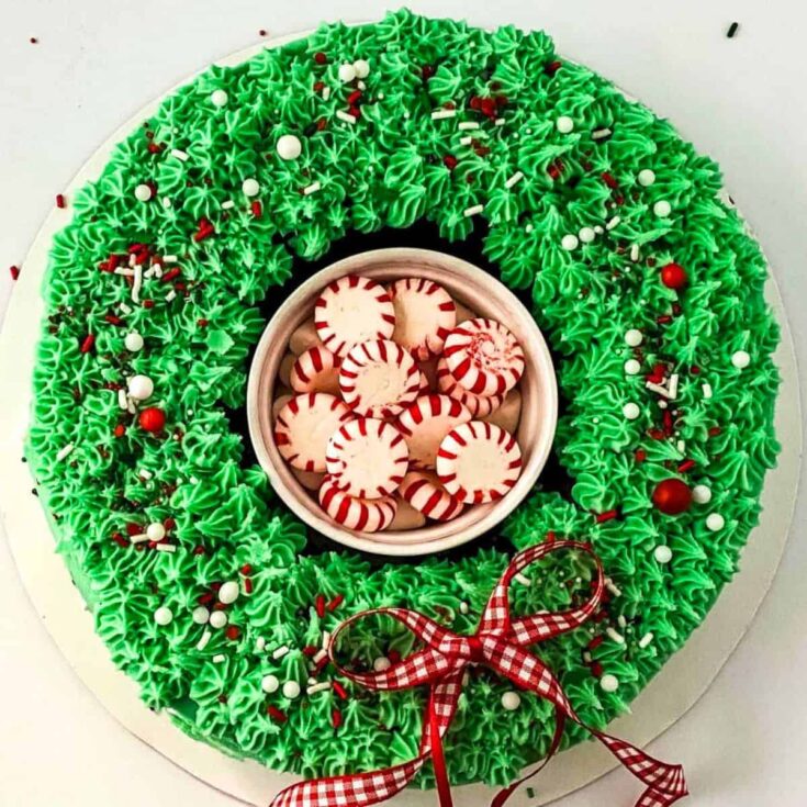 Red velvet Christmas wreath cake topped with green icing and sprinkles, baked after reading these Christmas cake recipes