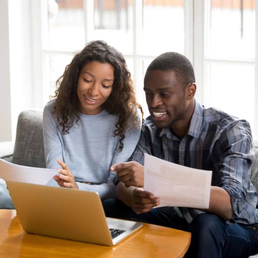 A couple organizing their shared bank accounts after reading these 10 tips for a happy marriage