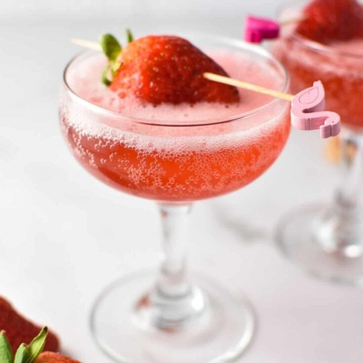 Sparkling strawberry mocktail topped with a strawberry, made after reading these non-alcoholic pink drinks for Valentine's Day
