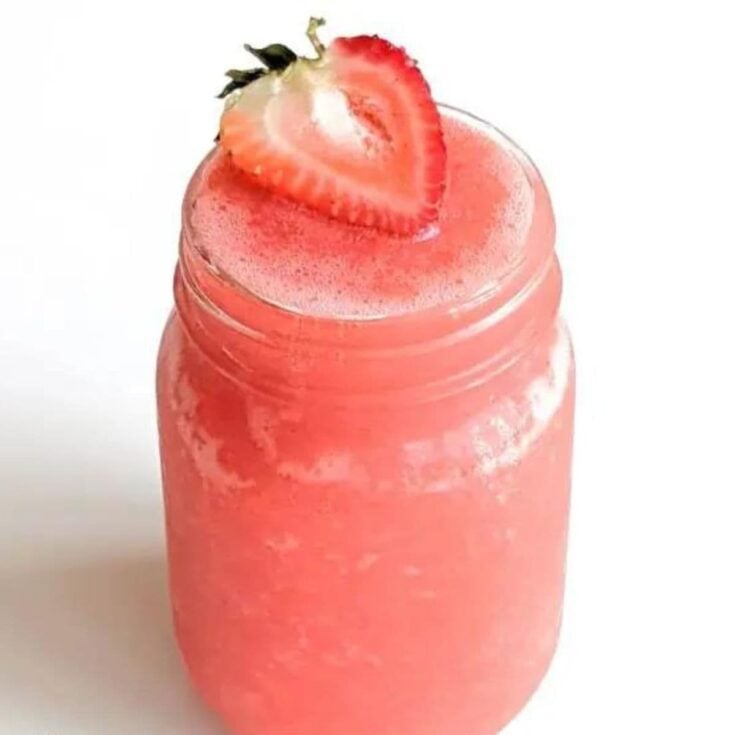 Starbucks blended strawberry lemonade topped with a sliced strawberry, made after reading these non-alcoholic pink drinks for Valentine's Day
