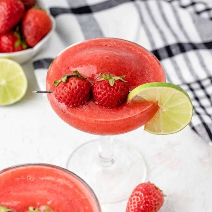 Strawberry daiquiri mocktail topped with strawberries, made after reading these non-alcoholic pink drinks for Valentine's Day