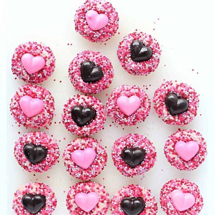 Strawberry shortbread cookies topped with hearts and sprinkles, made after reading these Valentine cookies