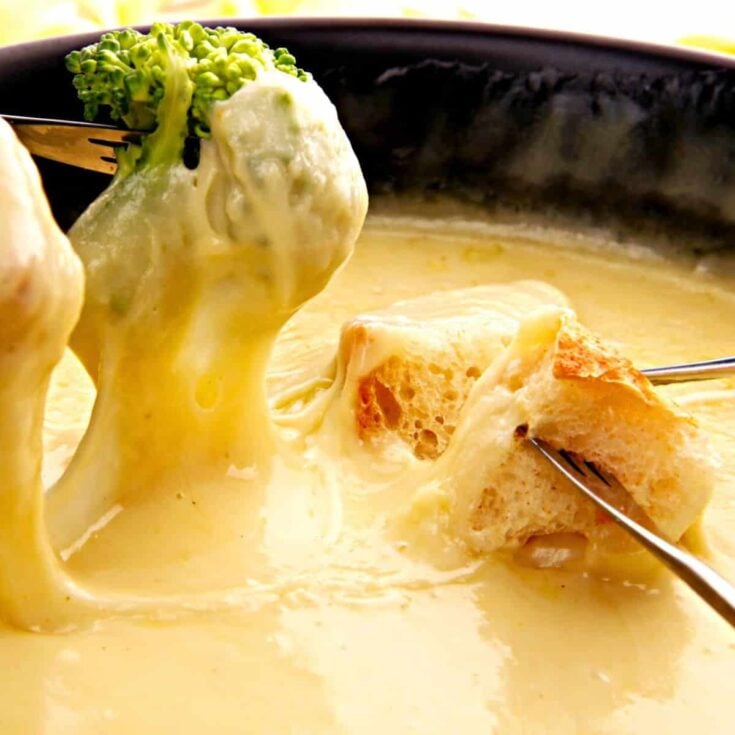 A bread and broccoli dipped on a Vegan beer cheese fondue after reading these Easy fondue recipes