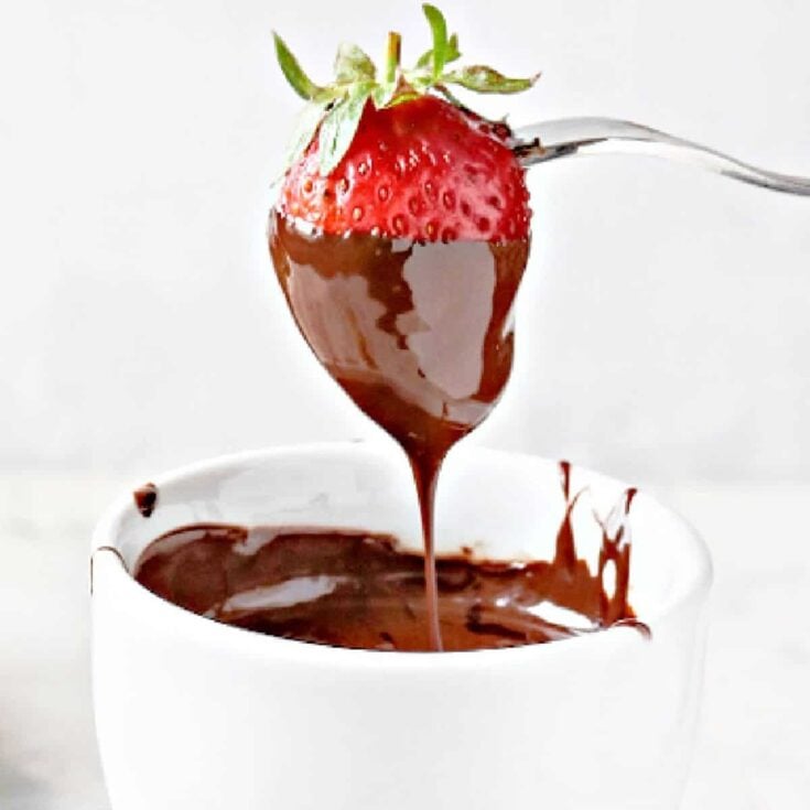 A straberry dipped on a vegan chocolate fondue after reading these Easy fondue recipes