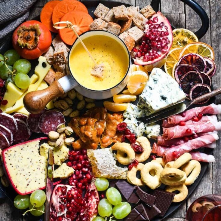 Winter cheese board with cheese fondue prepared after reading these Easy fondue recipes