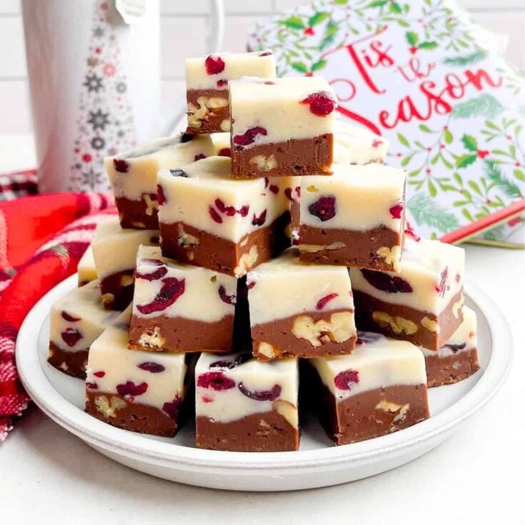 A stack of cranberry pecan fudge made after reading these Christmas candy recipes