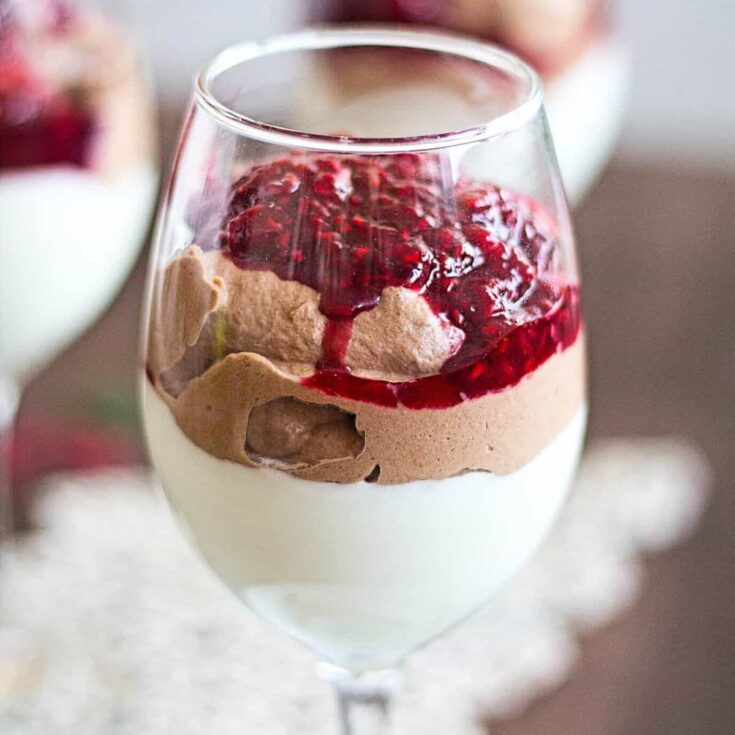 A glass of double chocolate mousse with raspberry sauce made after reading these Valentines Day Desserts