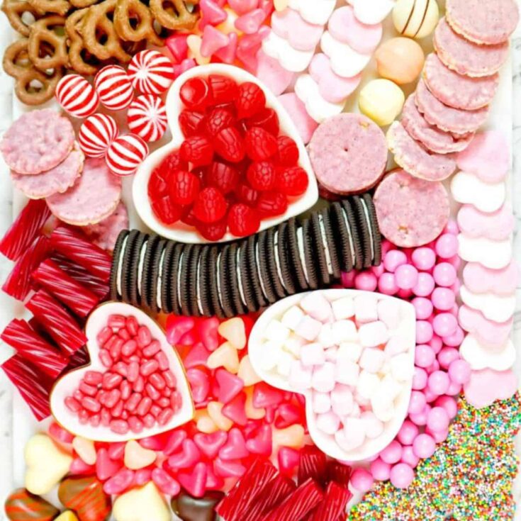 Valentines Day charcuterie board filled with oreos, candies, pretzels and more, made after reading these Valentines appetizers
