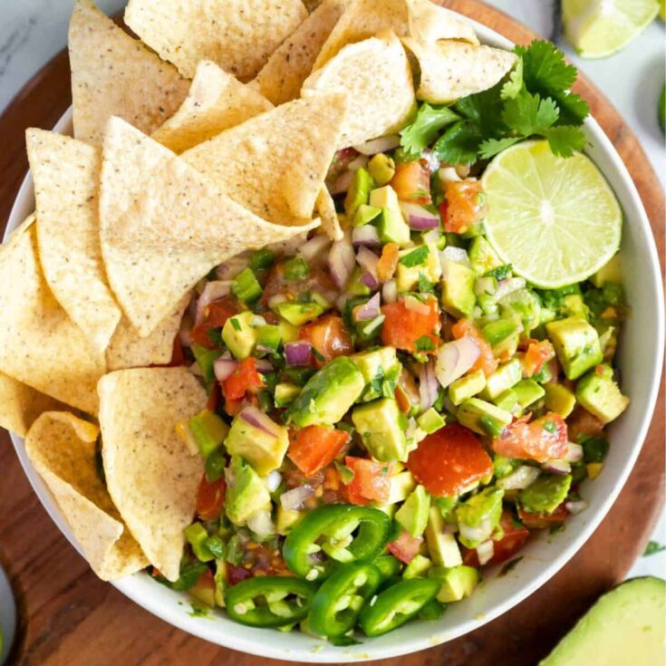 A bowl of avocado pico de gallo made after reading these Mexican appetizers for Cinco de Mayo