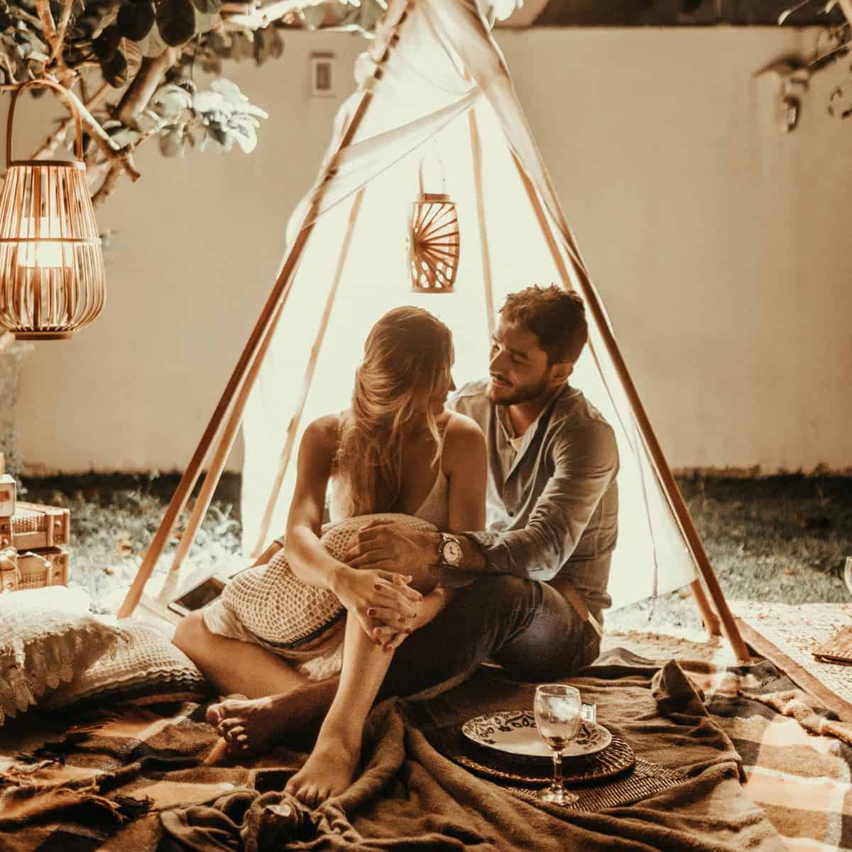 A couple having a themed romantic date with pillows and blankets: Unique date ideas