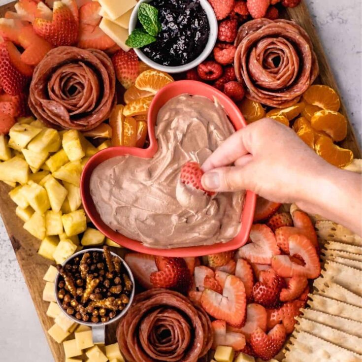 Valentines Day charcuterie board filled with fruits, cheese, and more, made after reading these Valentines appetizers