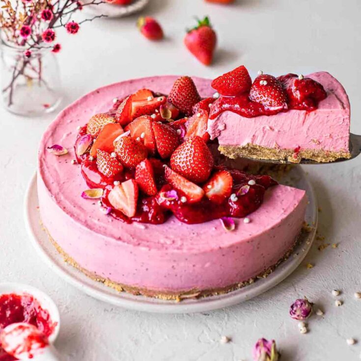 Vegan strawberry cheesecake topped with strawberries made after reading these Valentines Day Desserts