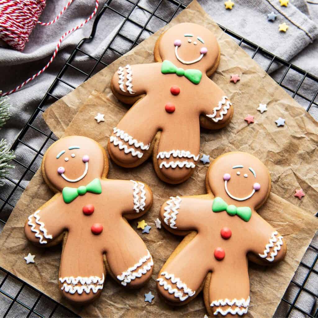 Three gingerbread cookies baked after reading these Christmas date ideas