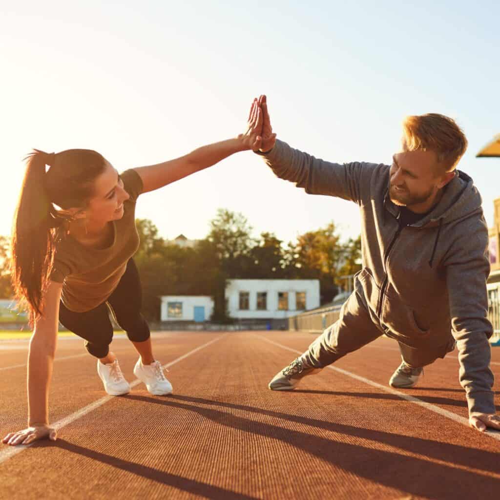 A couple exercising together after reading these Fitness dates for couples