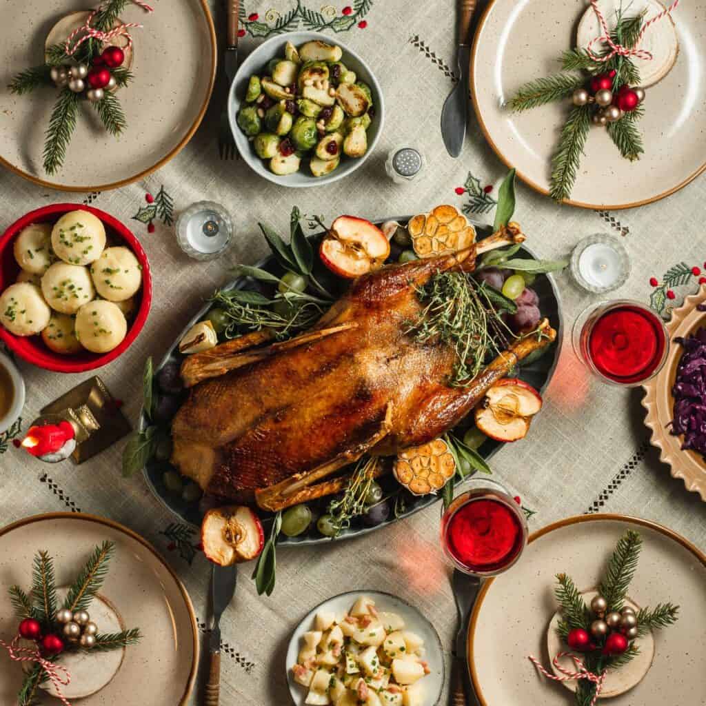A table filled with food and Christmas decorations, prepared after reading these Christmas date ideas