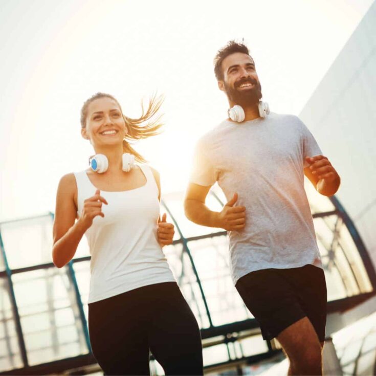 A happy couple jogging together after reading these Fitness dates for couples