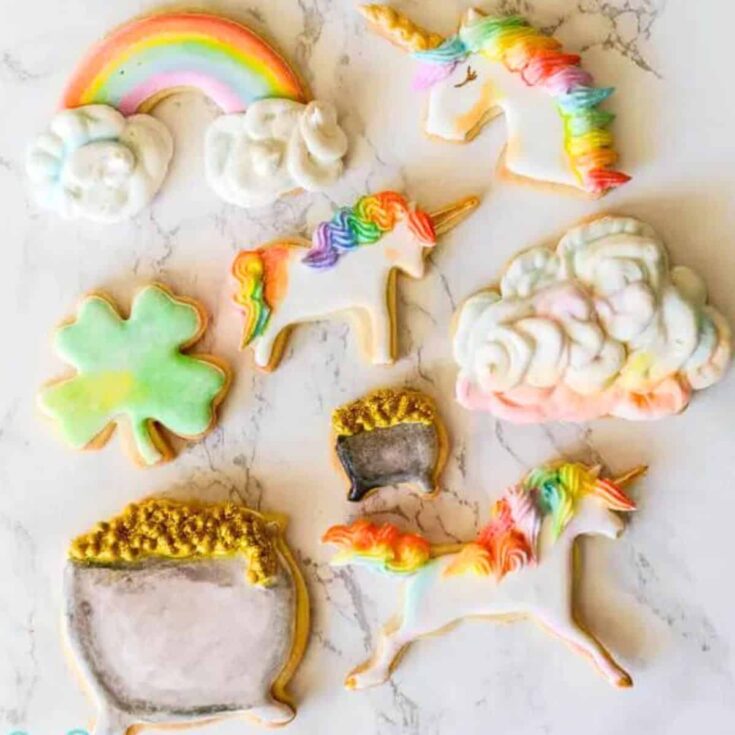 Pot of gold, unicorn, lucky leaf, and rainbow shaped cookies made after reading these St Patricks Day cookies