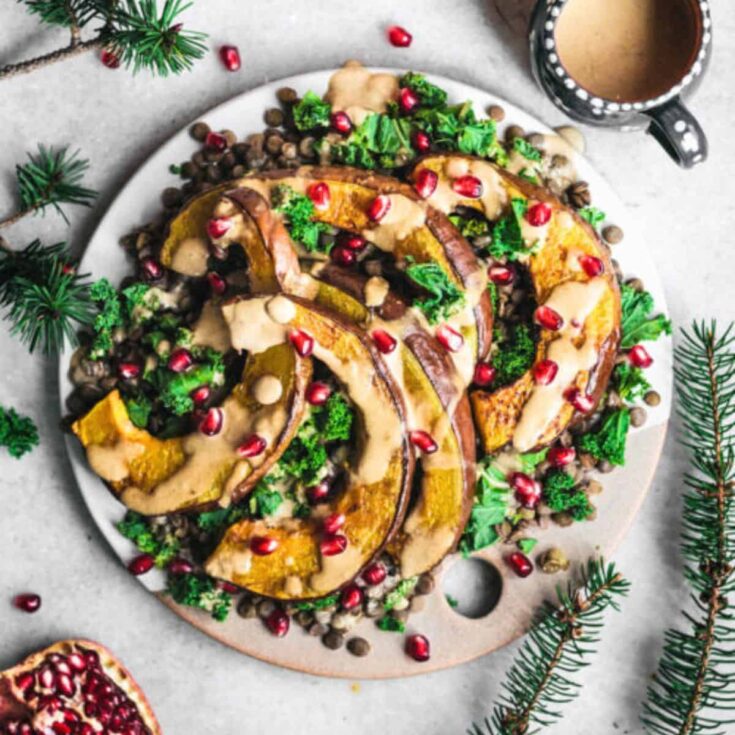 A plate of roasted pumpkin with lentils kale and tahini dressing made after reading these Fresh pumpkin recipes