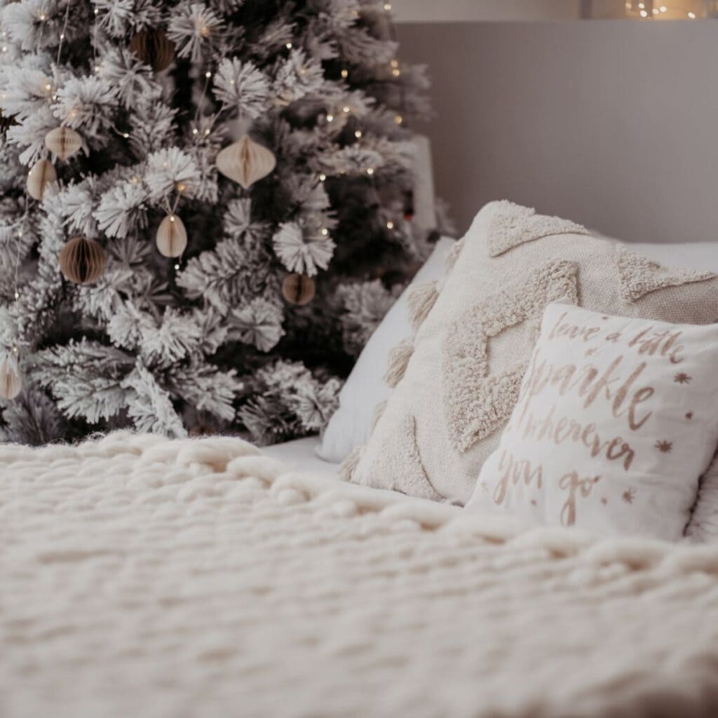 A Christmas tree placed beside the bed after reading these Christmas date ideas