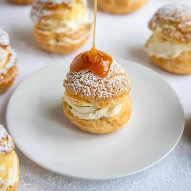 A plate of Craquelin choux buns with apple compote made after reading these Bite sized desserts