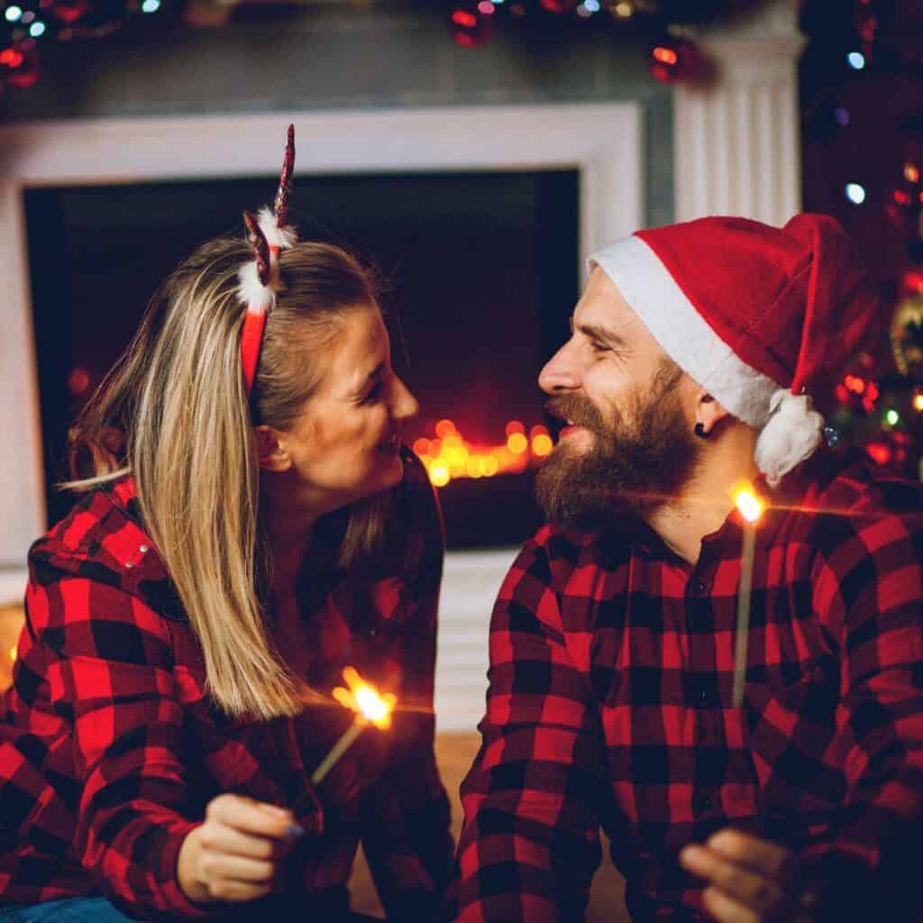 A happy couple looking at each other after reading these tips on How to survive your family Christmas