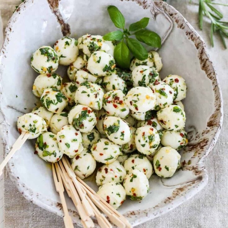 A bowl of marinated mozzarella balls made after reading these One bite appetizers