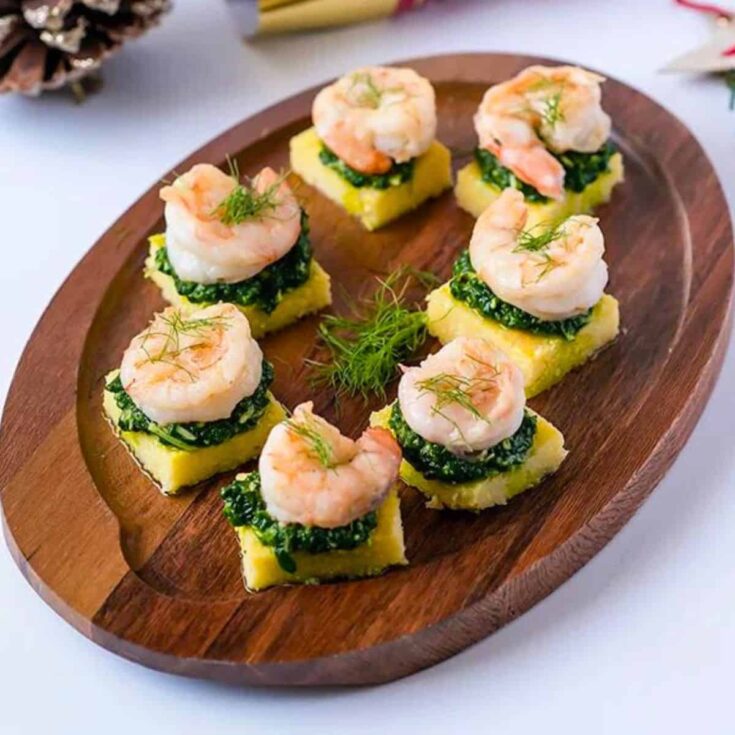 Polenta squares with garlic shrimp and spinach pesto made after reading these New Years Eve appetizers