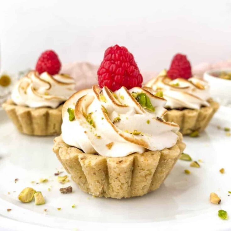 A set of raspberry tartlets with pistachio tart crust made after reading these Bite sized desserts