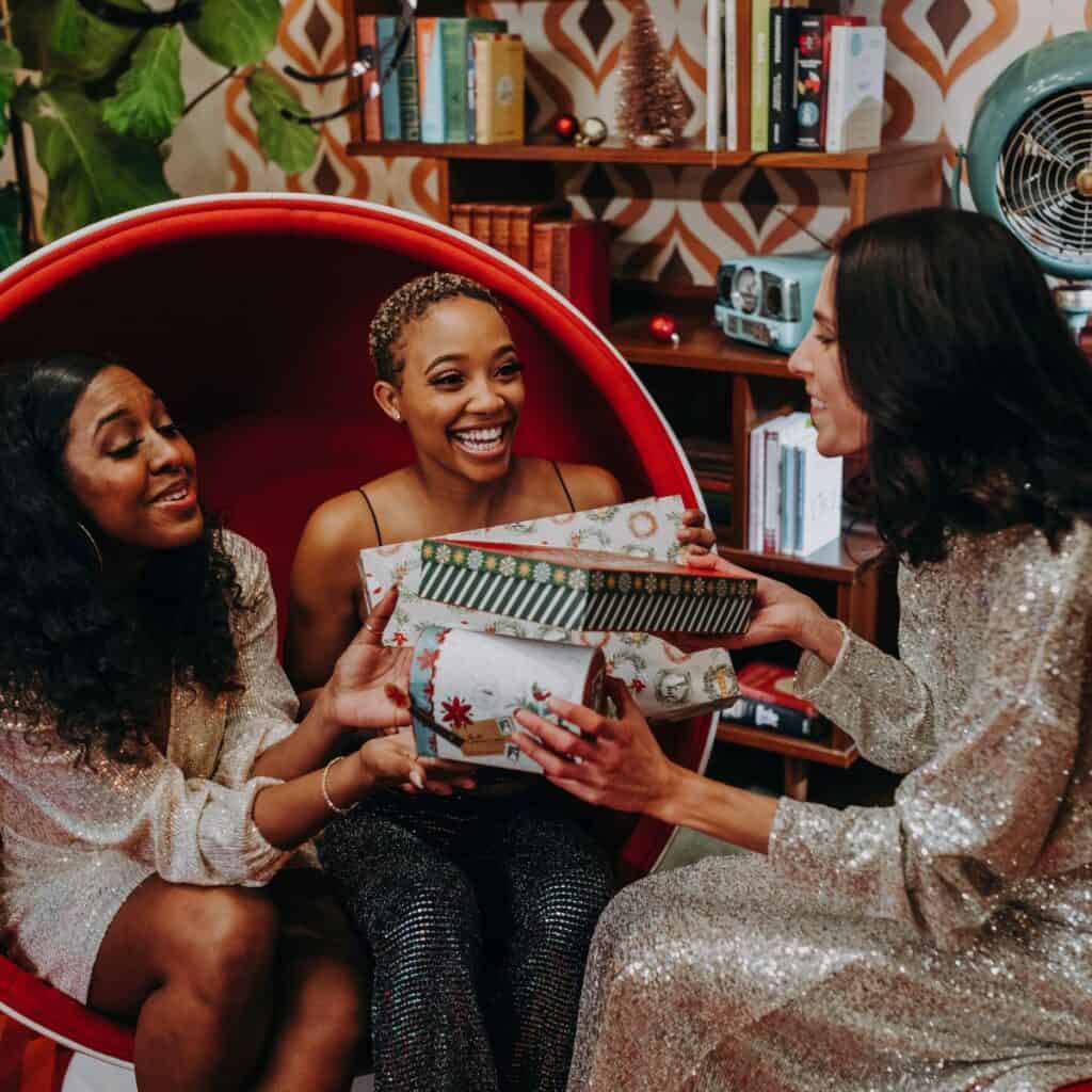 Ladies exchanging gifts: How to survive your family Christmas