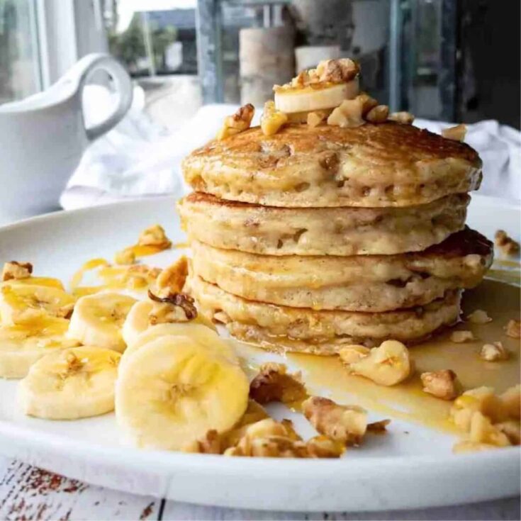 A plate of banana walnut and ricotta buttermilk pancakes
