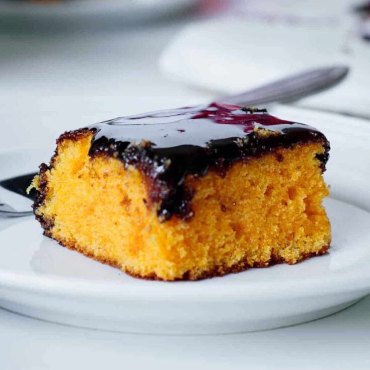 A slice of Brazilian carrot cake with chocolate sauce