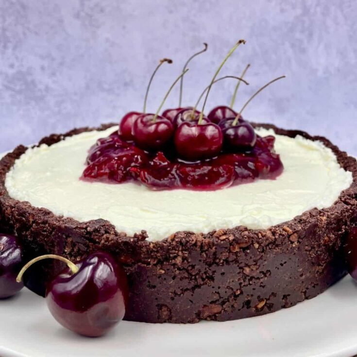 Cherry cheesecake with chocolate crust, topped with cherries