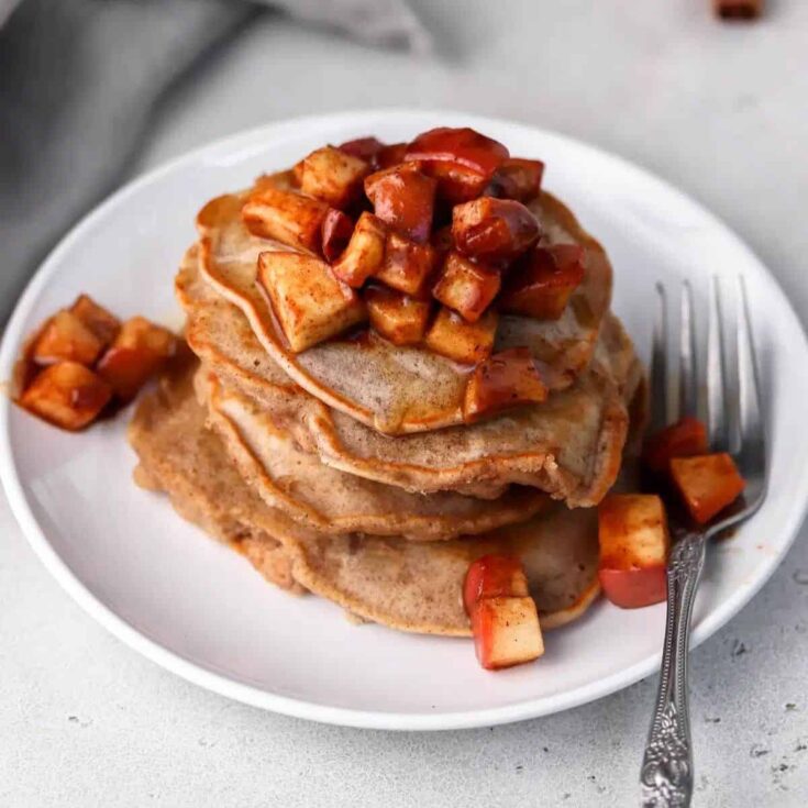 Cinnamon apple pancakes topped with sliced apples