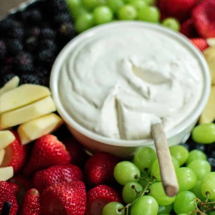 Cream cheese fruit dip surrounded by fresh fruits