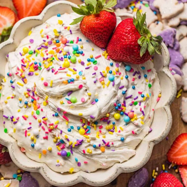 A bowl of Dunkaroo dip topped with sprinkles and strawberries