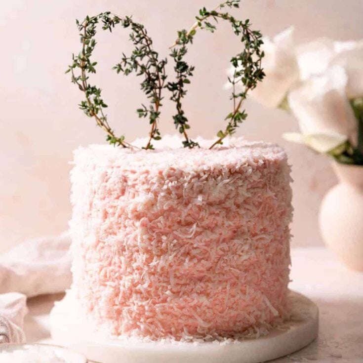 Easter coconut cake with a bunny ear shaped vine on top
