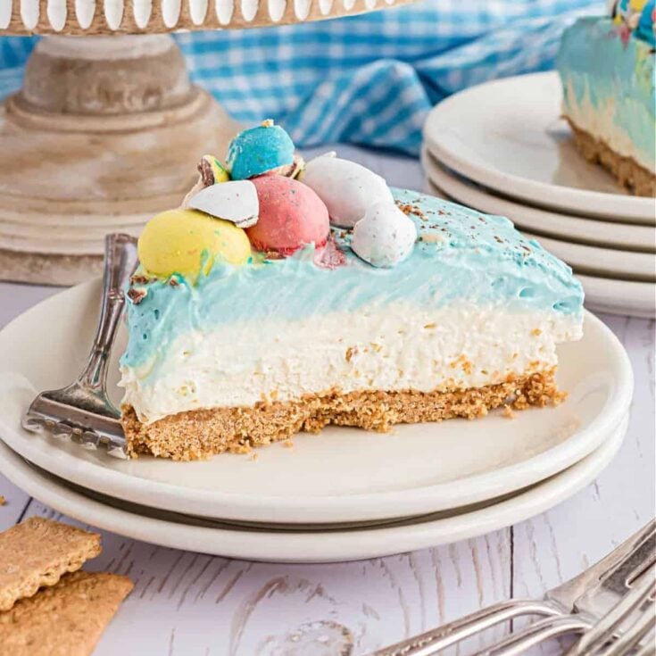 A slice of Easter egg cheesecake topped with little Easter eggs