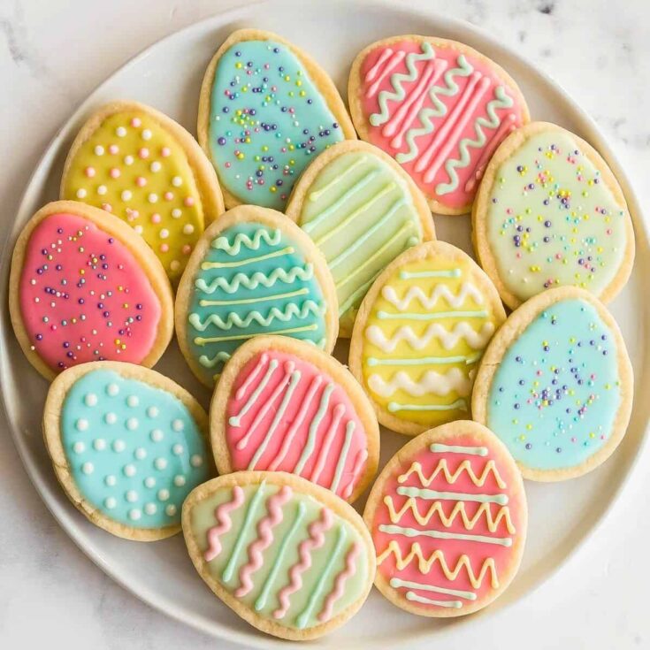 A plate filled with colorful Easter egg sugar cookies