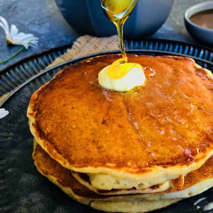 Eggless banana pancakes topped with maple syrup and butter