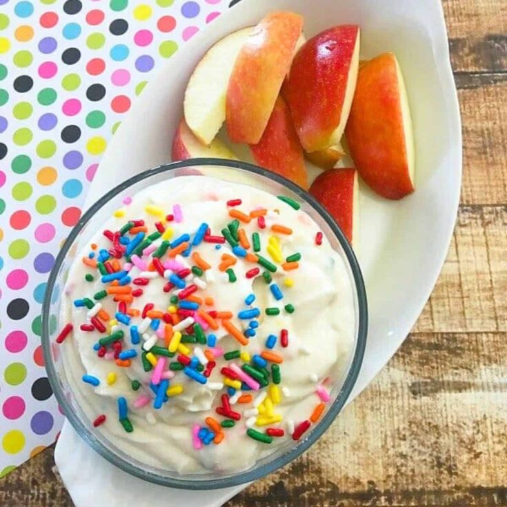 Funfetti Greek yogurt fruit dip with sliced apples on the side