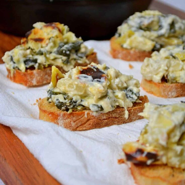 Toasted bread topped with gluten free spinach artichoke dip
