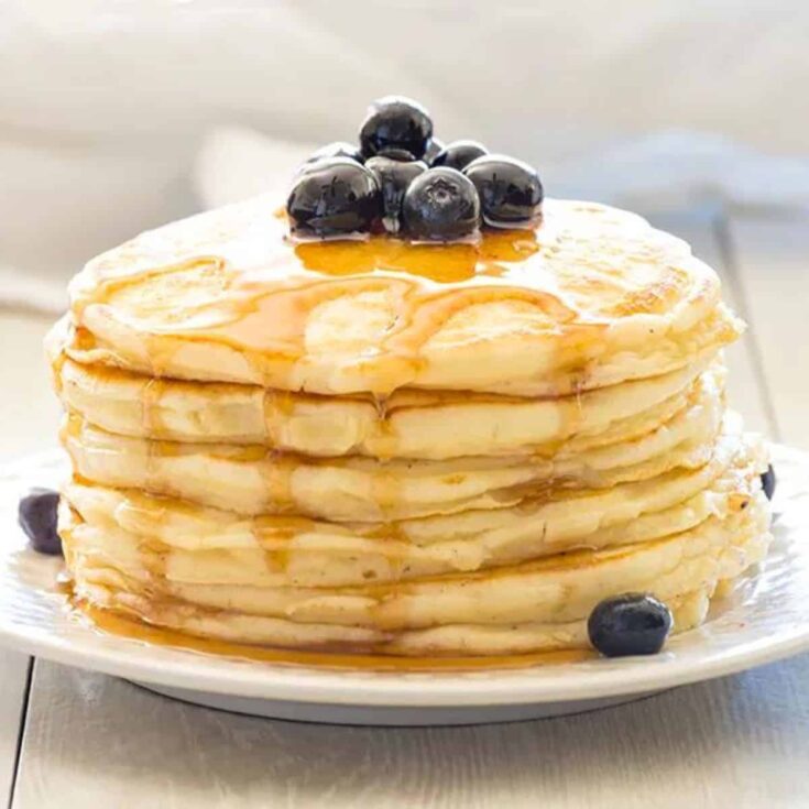 Greek yogurt pancakes on a plate topped with blueberries