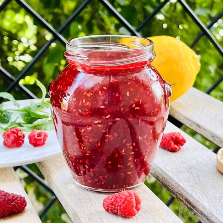 A small jar of homemade raspberry sauce