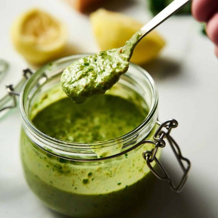 A jar of lemon pesto with basil pine nuts and parmesan
