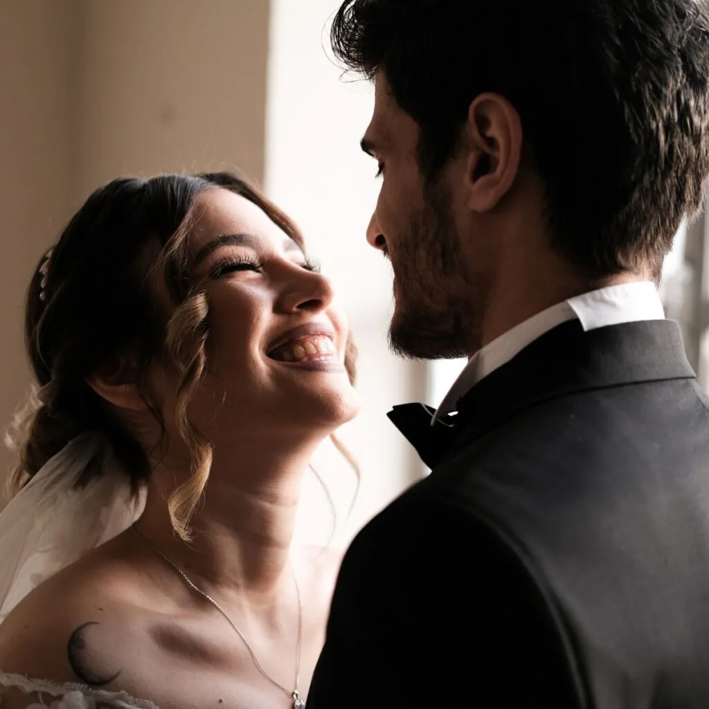 A newly wedded couple smiling at each other: The best marriage advice in 5 words or less