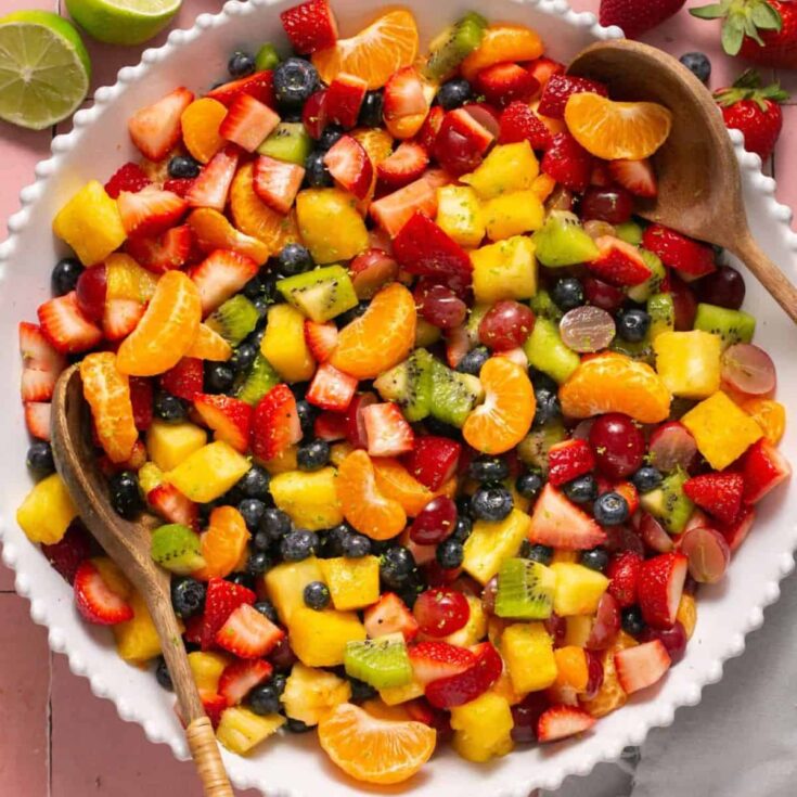 A bowl of rainbow fruit salad with honey lime
