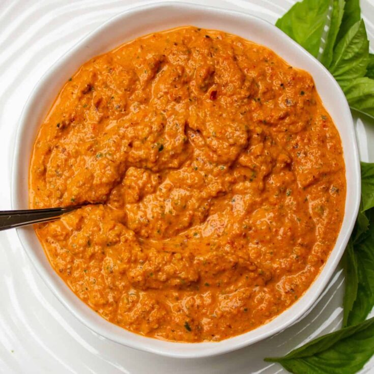 A bowl of red pepper sauce and dip