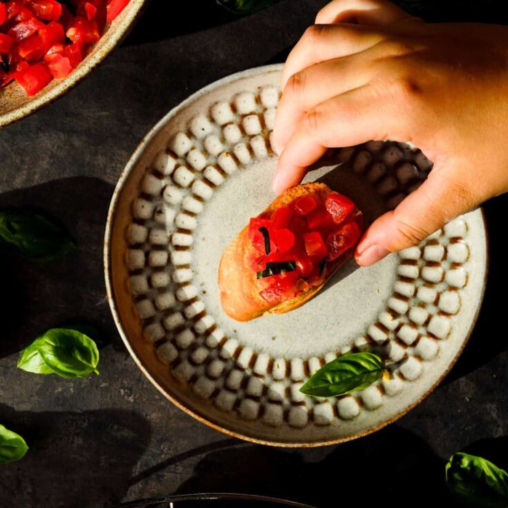 Simple tomato bruschetta with basil on a plate